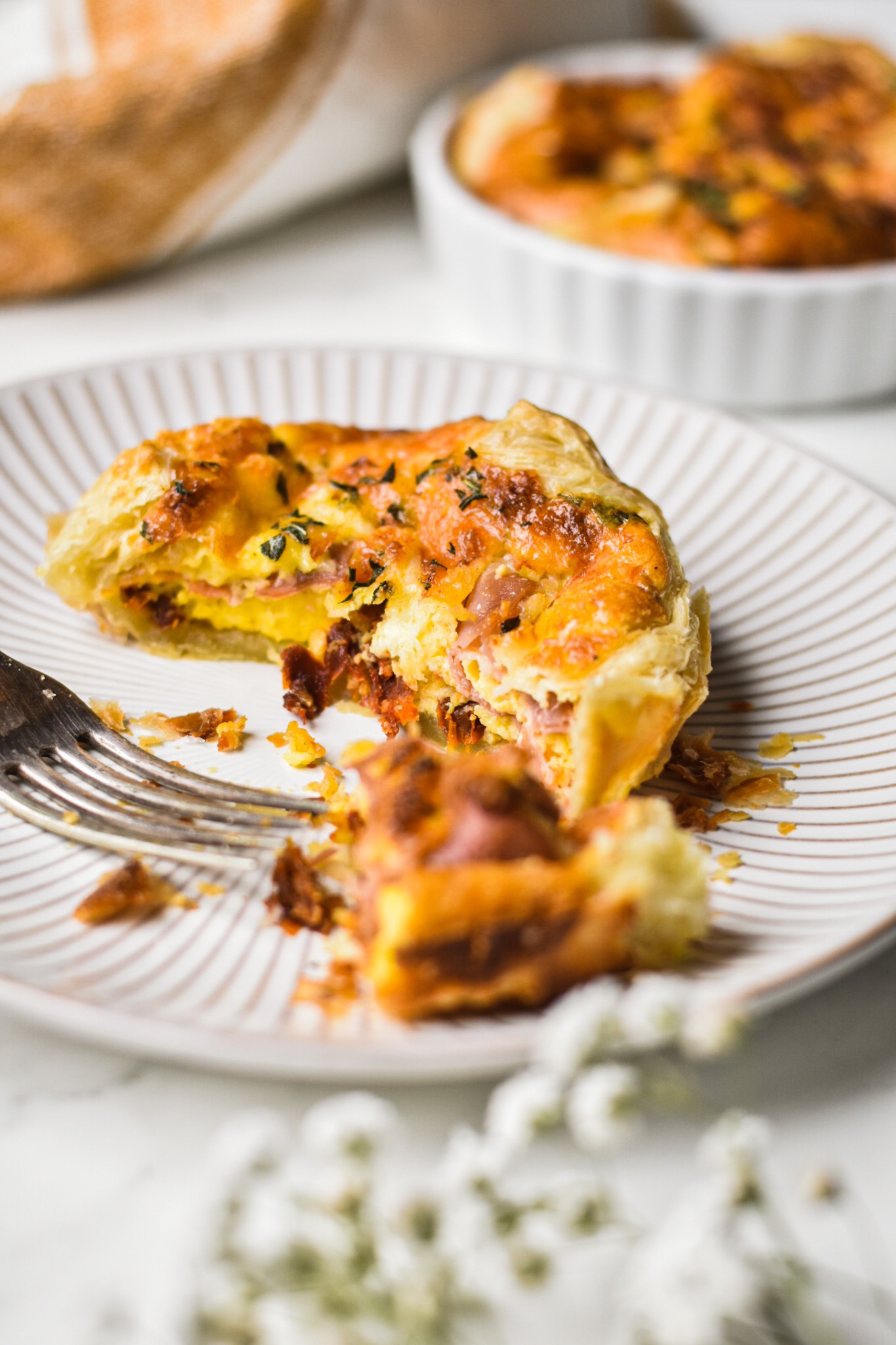 Copycat panera souffle on a plate broken in half with a fork.