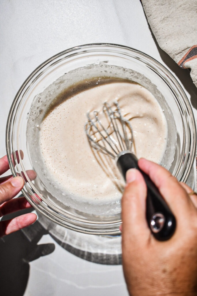 Whisking together the dry ingredients with milk.