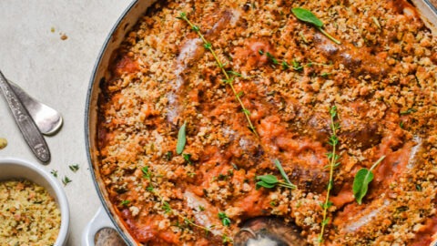 White bean and sausage cassoulet on a wooden board.