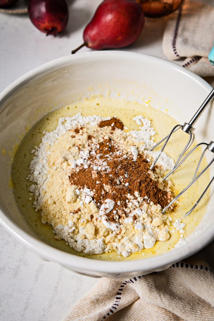 Whisking in flour and other dry ingredients into the wet ingredients.