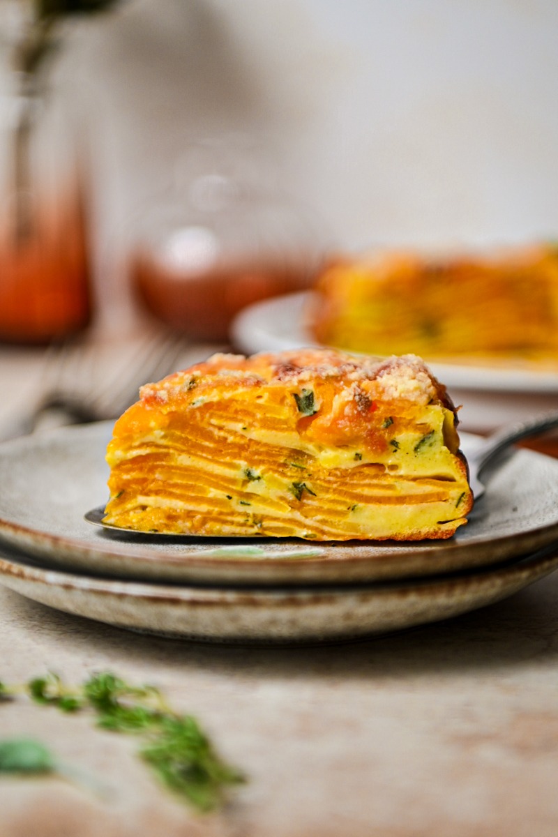 Side view of a slice of butternut squash invisible cake on a plate.