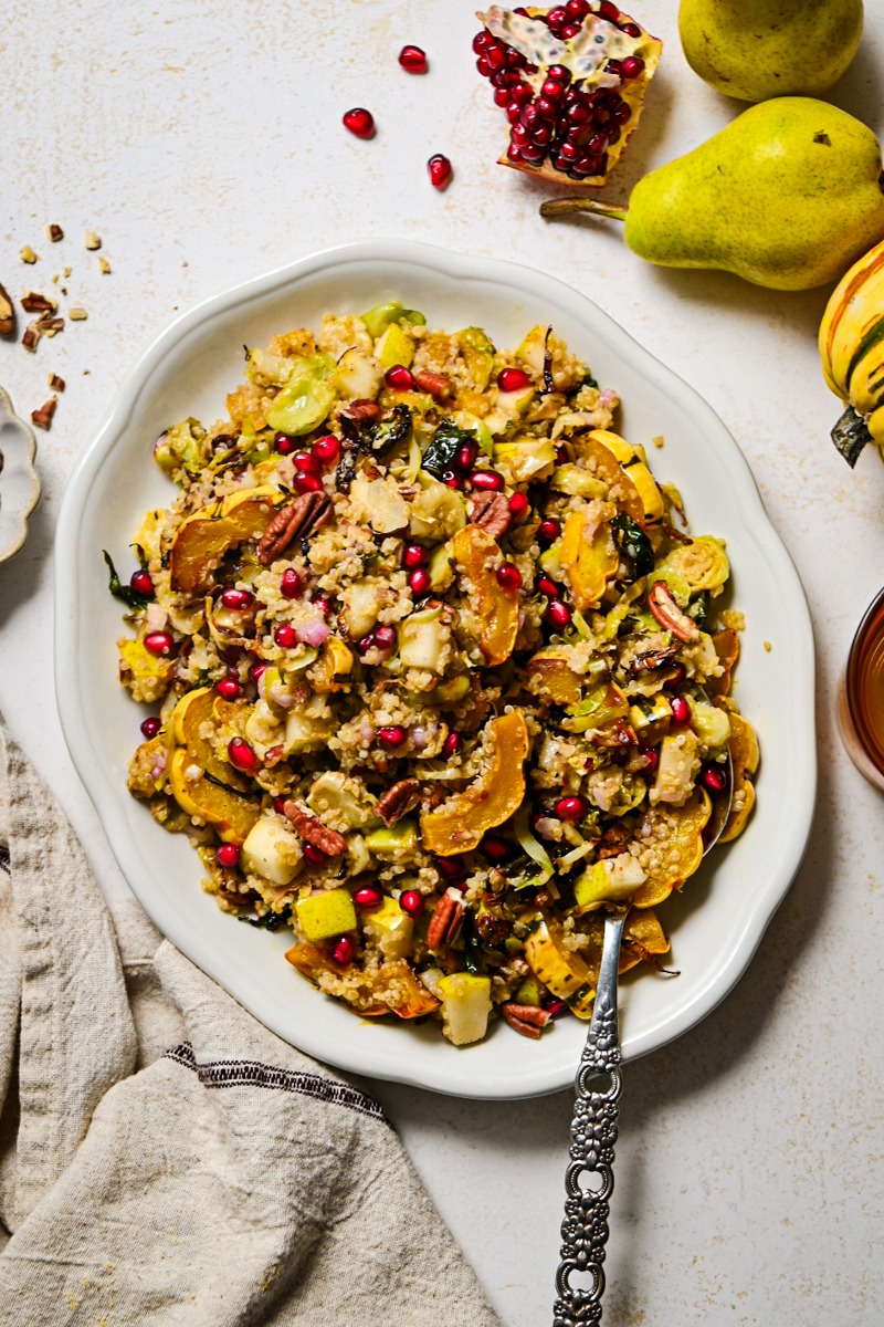 Fall quinoa salad served on a serving platter with a serving spoon.