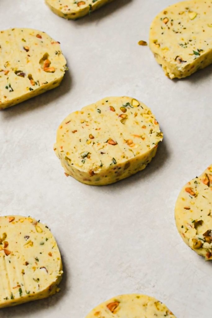 Sliced savory shortbread placed on a sheet pan.