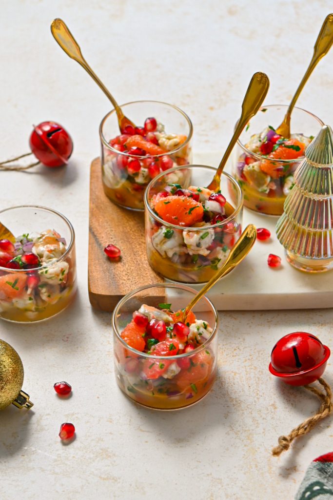 Winter citrus pomegranate shrimp ceviche all mixed together in a glass container.