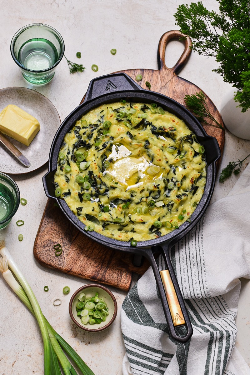 Overhead shot of Irish colcannon in skillet with butter melting on top.
