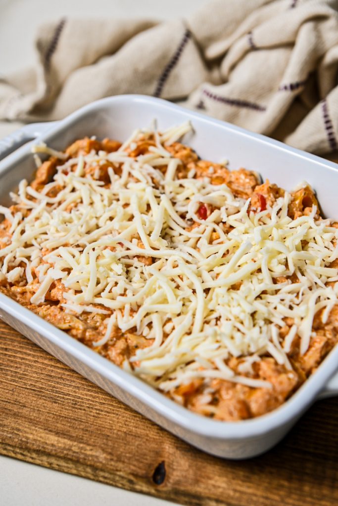 Ricotta dip mixture transferred to a baking dish and topped with more mozzarella cheese.