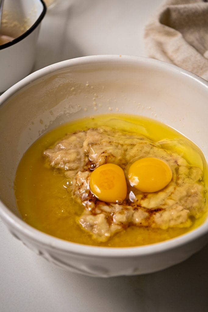 Eggs added to the wet ingredients for banana bread.