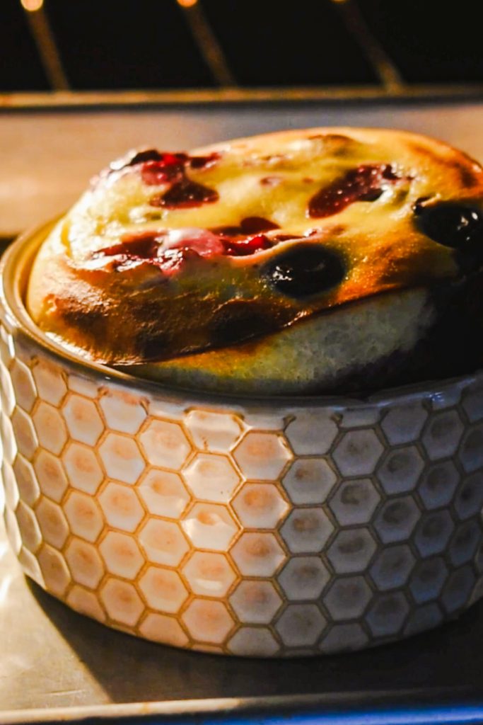 Side view of berry baked yogurt being baked in an oven.