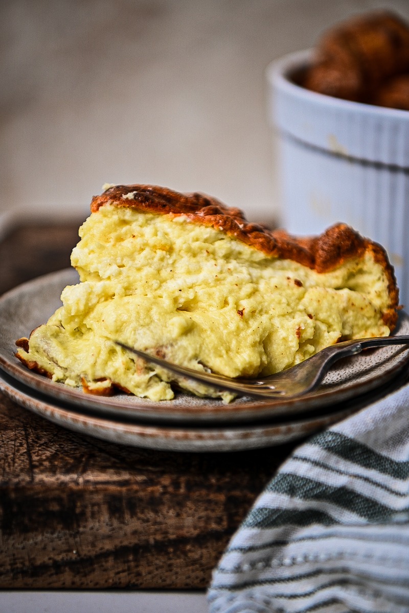 Slice of cheese souffle on a plate.