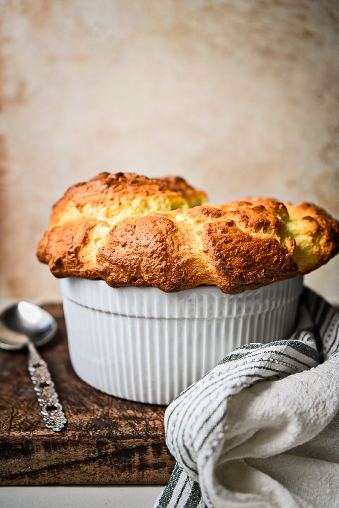 Side view of a classic French cheese souffle after being baked.