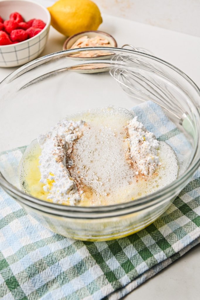 Dry ingredients in a bowl with frothy egg whites added.