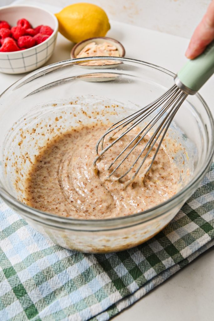 Whisking together the financier batter in a bowl.