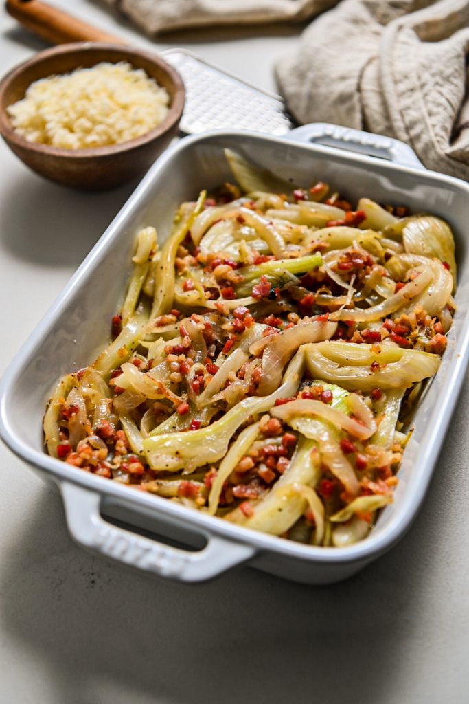 Fennel and pancetta mixture placed in a baking dish.