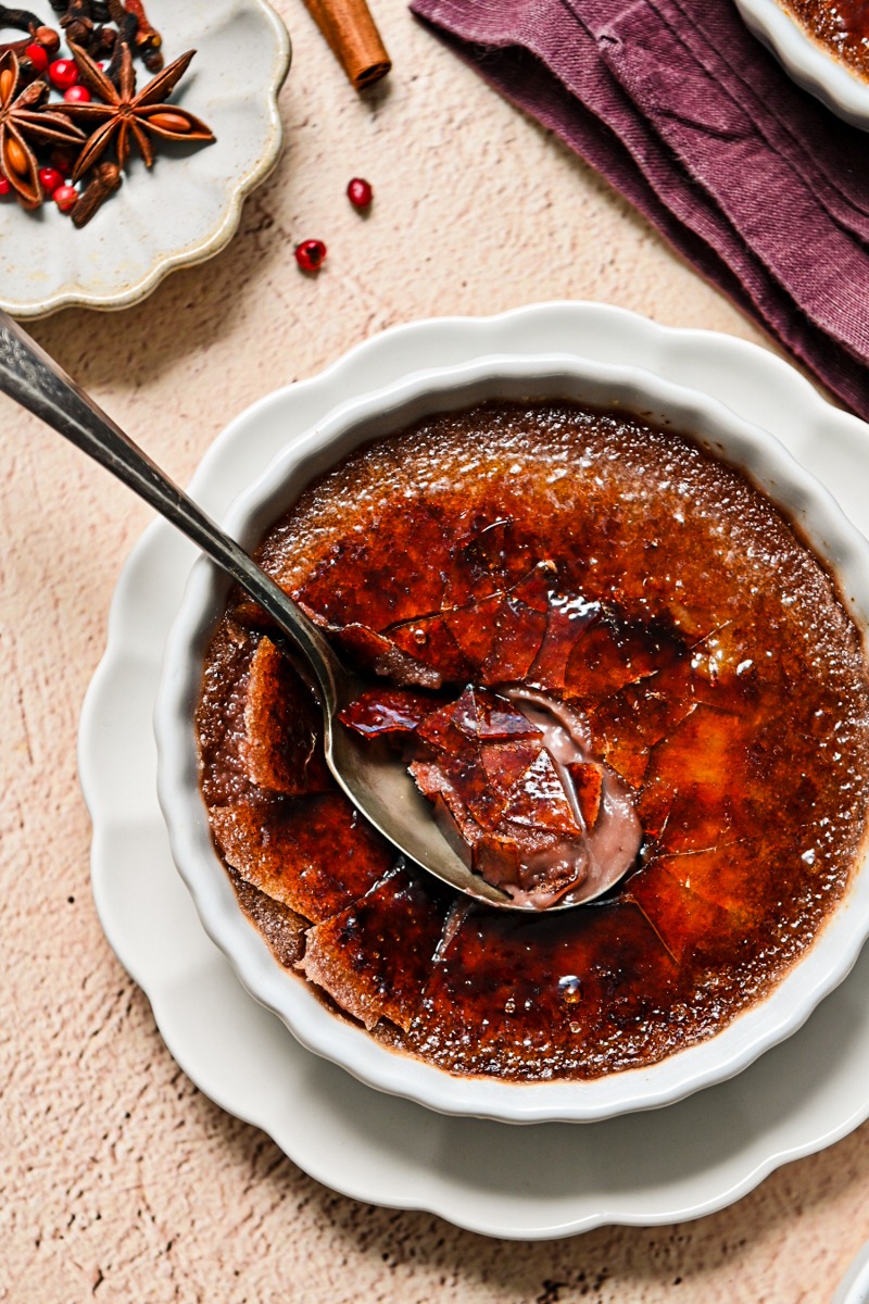 Mulled wine creme brulee cracked on the top with a spoon.