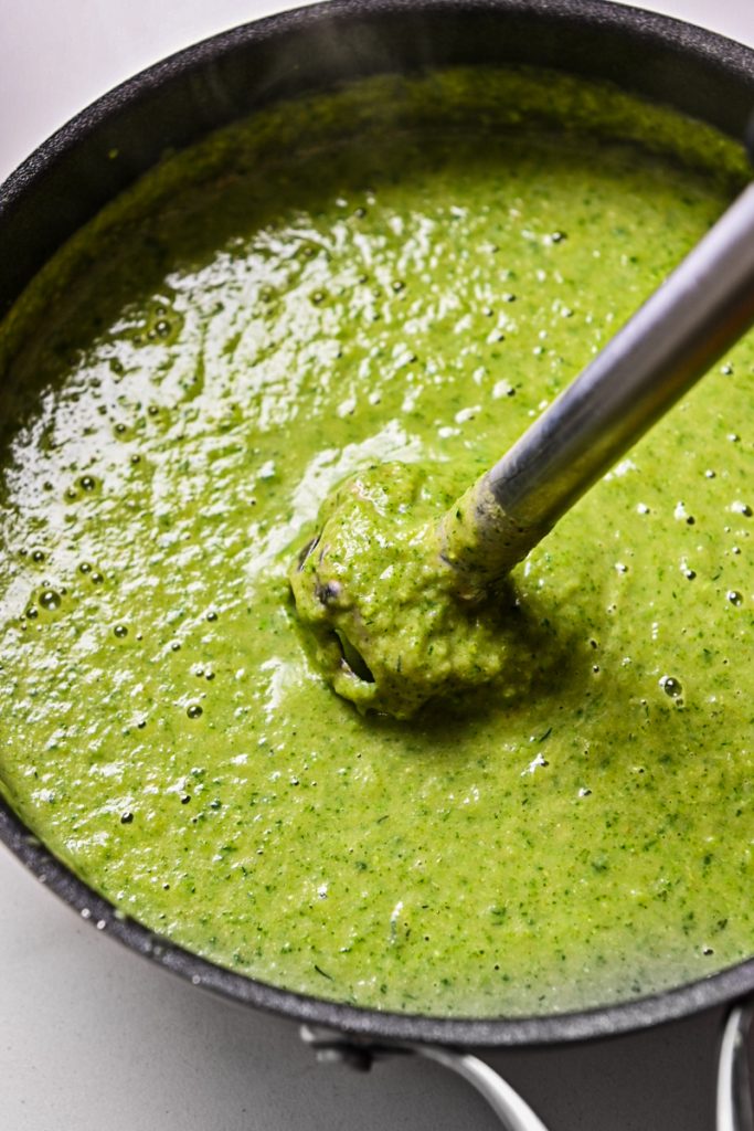 Immersion blender in the pot of greens and broth to blend everything together.
