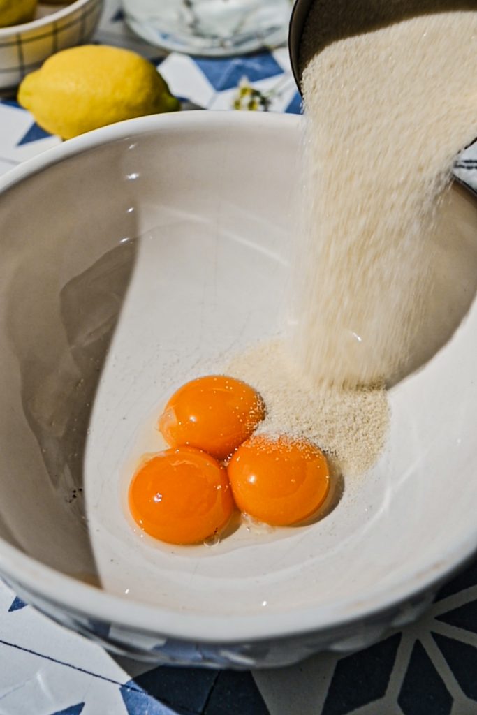 Egg yolks and sugar in a mixing bowl.