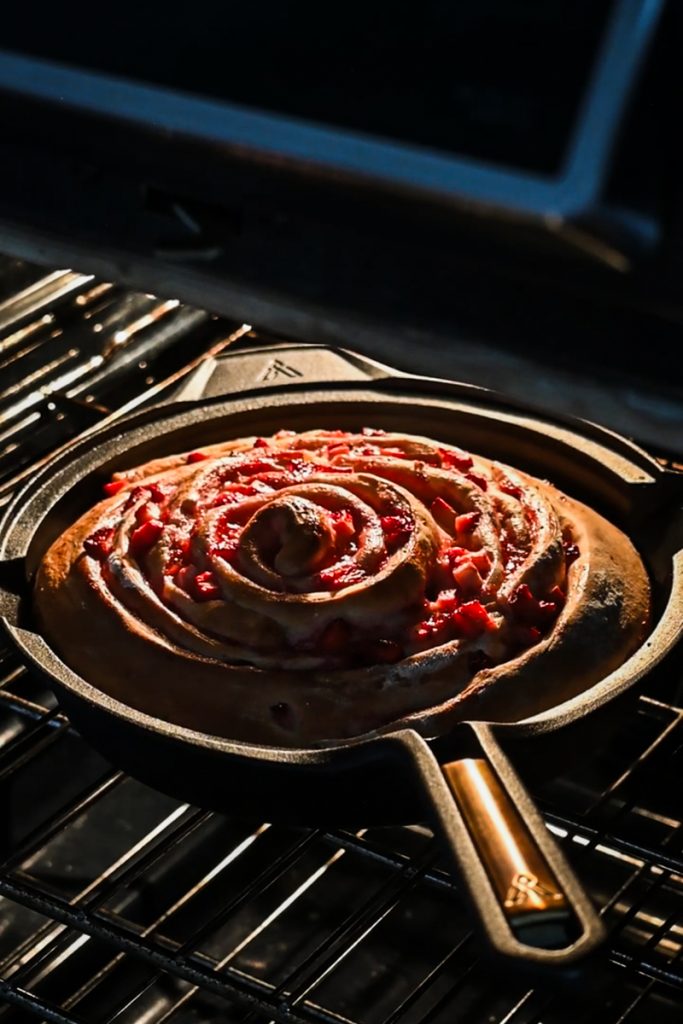 Giant strawberry roll cake in the oven to bake.