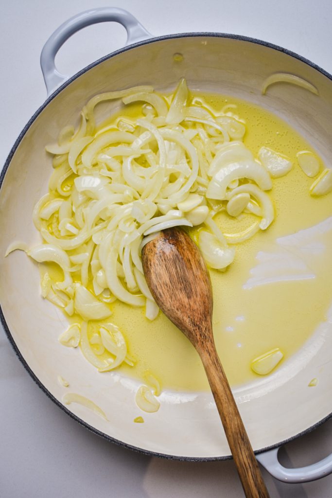 Sauteed garlic and onions in a skillet.