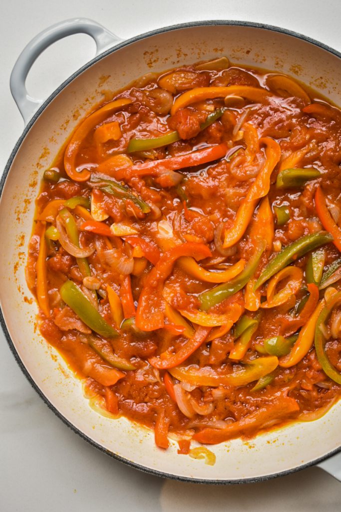 Simmering peperonata in a skillet.