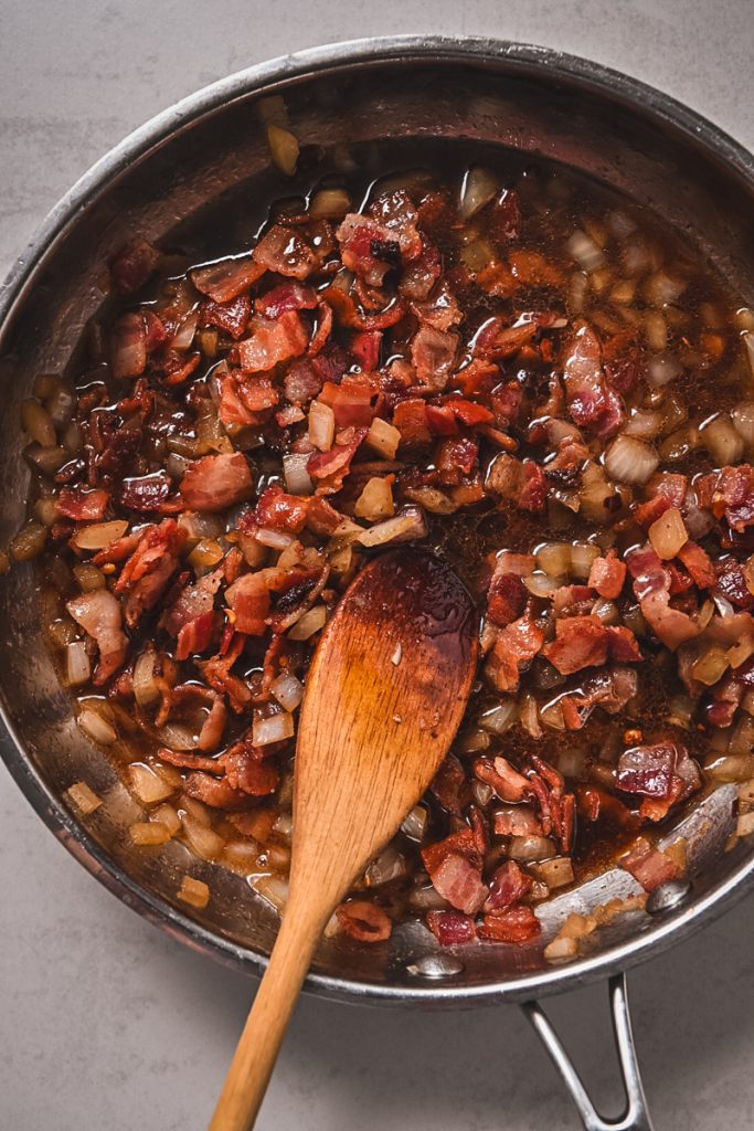 Image of adding bacon into the skillet.