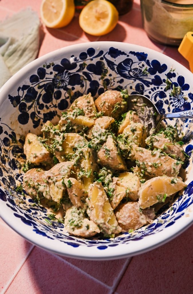 Tonnato potato salad mixed together in a bowl.