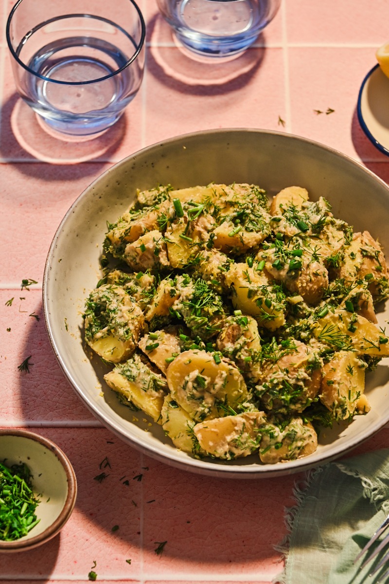 Side view of tonnato potato salad served in a bowl.