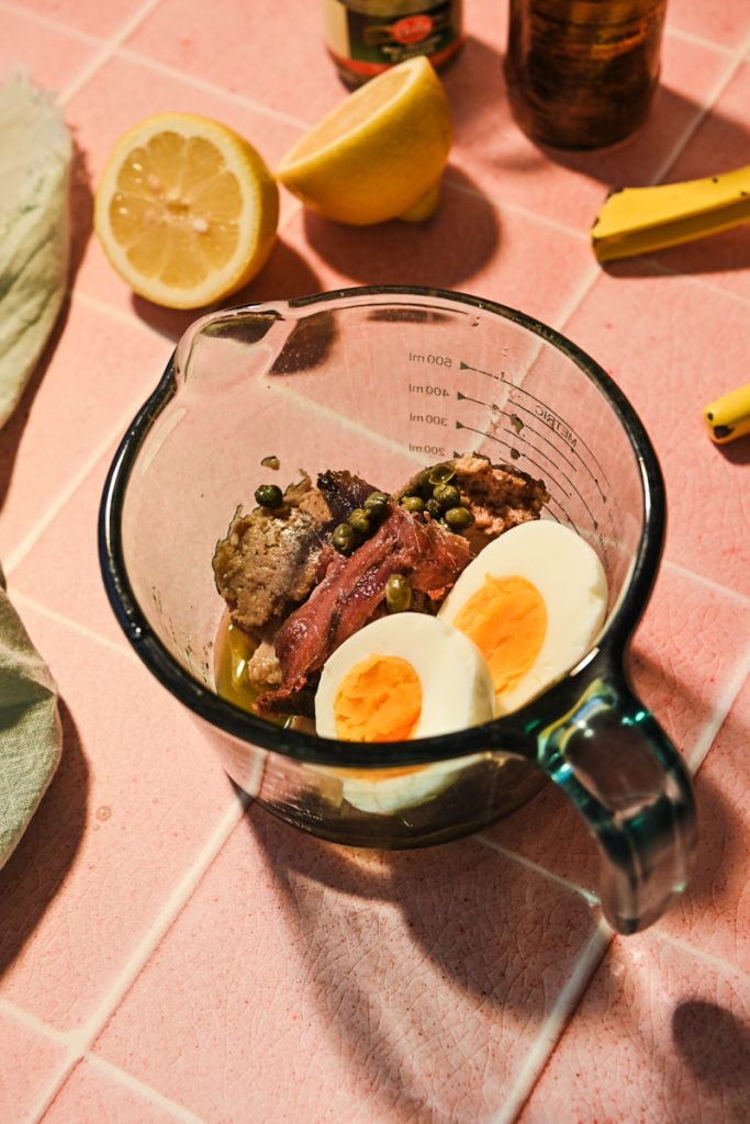 Tonnato sauce ingredients in a measuring cup before being blended.