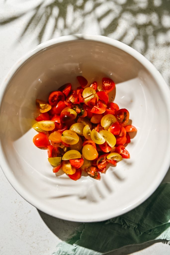 Sliced tomatoes in a mixing bowl.