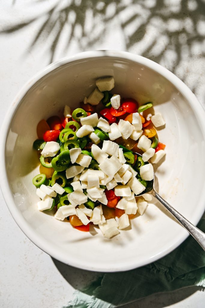 Sliced olives and fresh mozzarella added to the tomato salad.