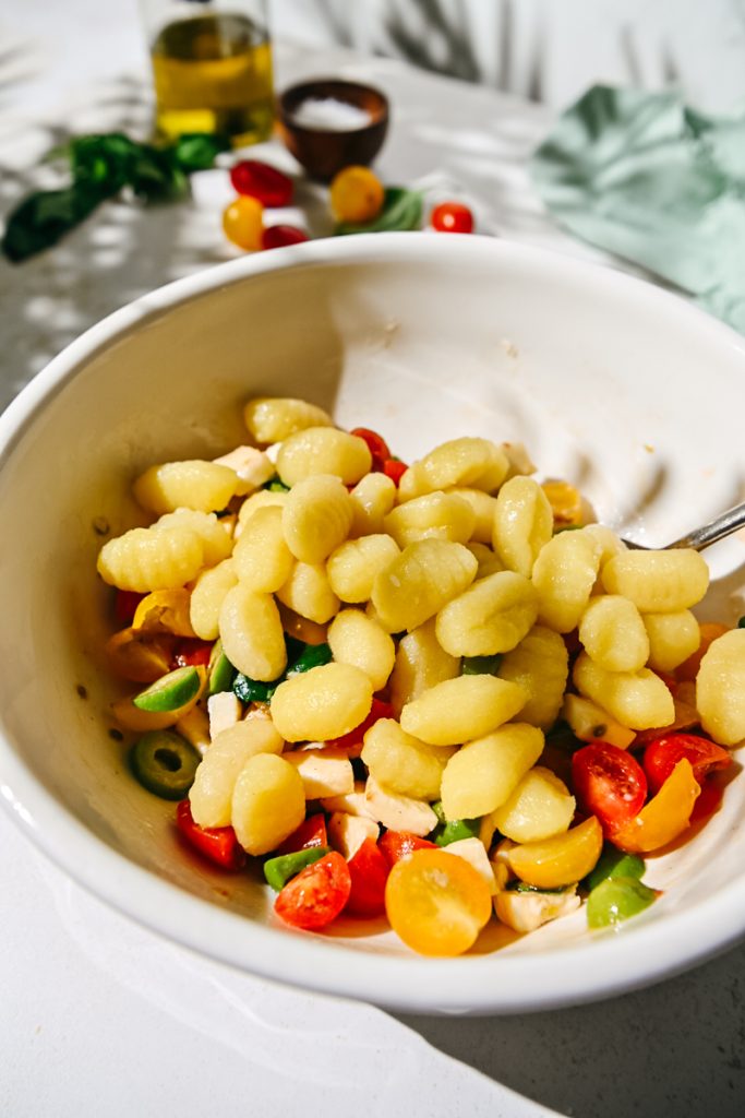 Cooked gnocchi added to the marinated tomatoes mixture.
