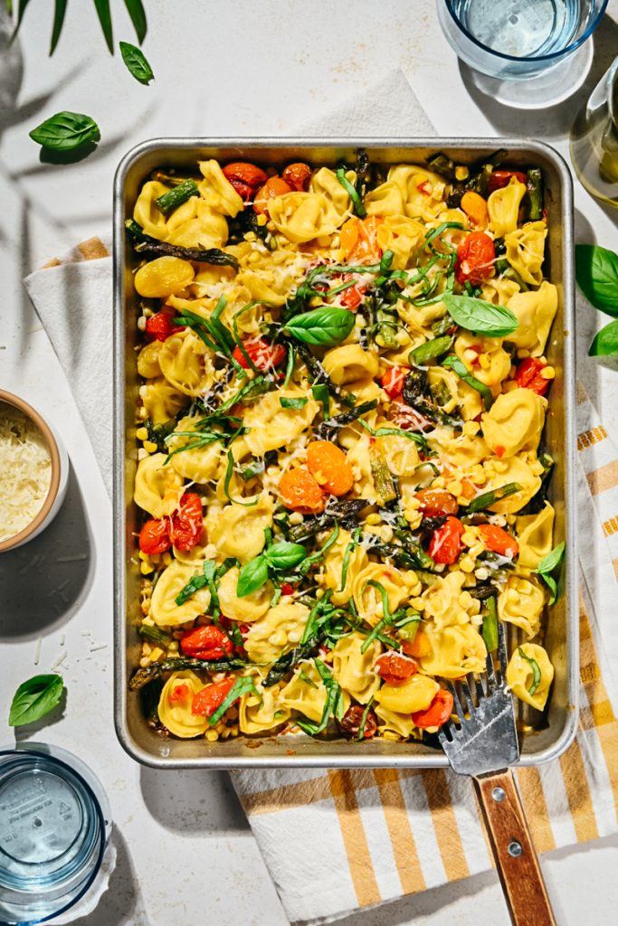 Finished summer sheet pan tortellini with parmesan on top.