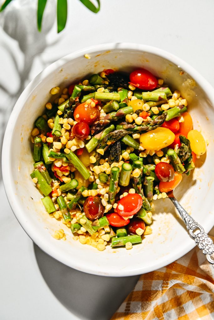 Corn, tomatoes, asparagus, Calabrian chili, olive oil, salt and pepper mixed together.