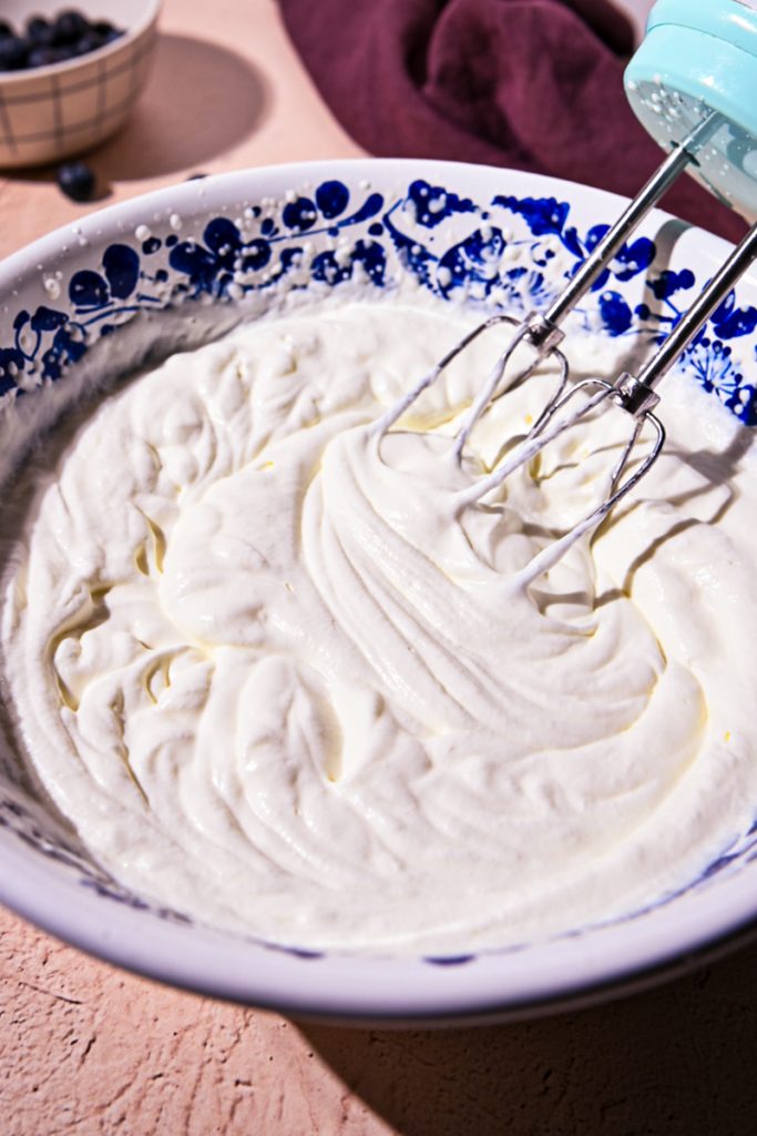Heavy cream whipped in a large bowl.