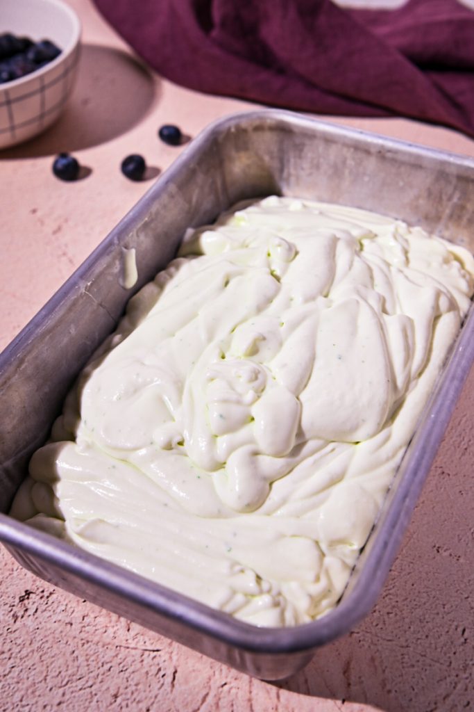 Basil ice cream mixture poured into a loaf pan.