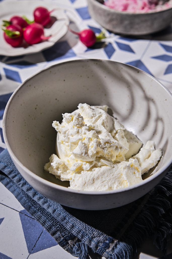 Whole milk ricotta placed in a small bowl.