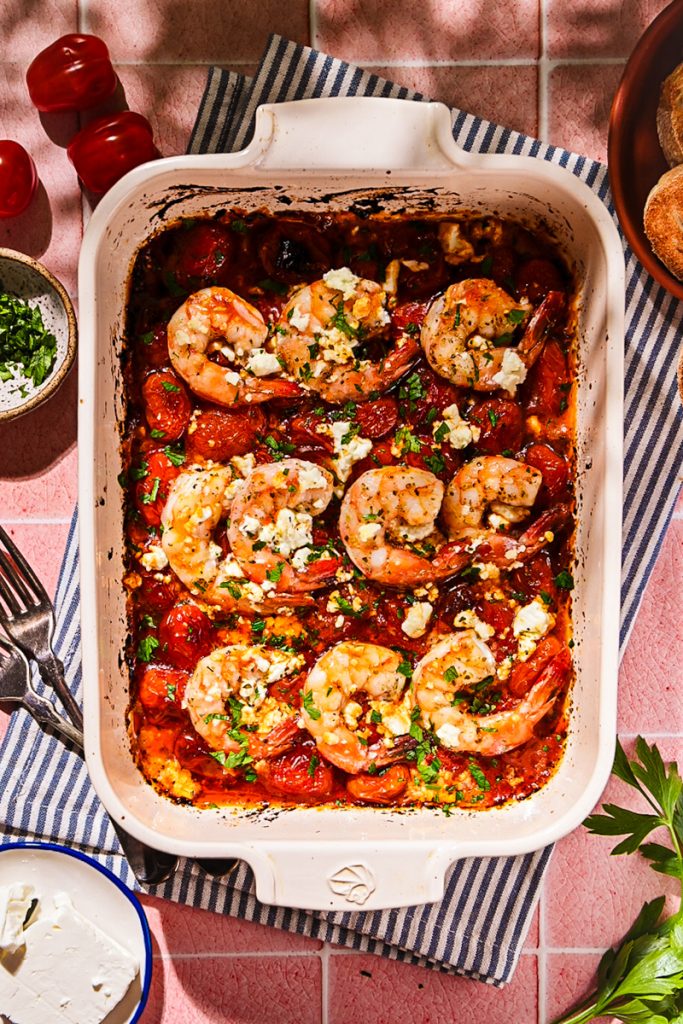 Overhead shot of finished shrimp saganaki in a baking dish.