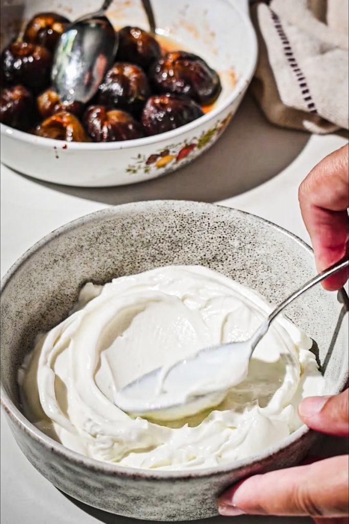 Yogurt being spread in the bottom of a bowl.
