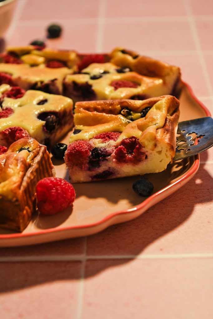 Side view of Crustless Yogurt Cheesecake Bars with Berries