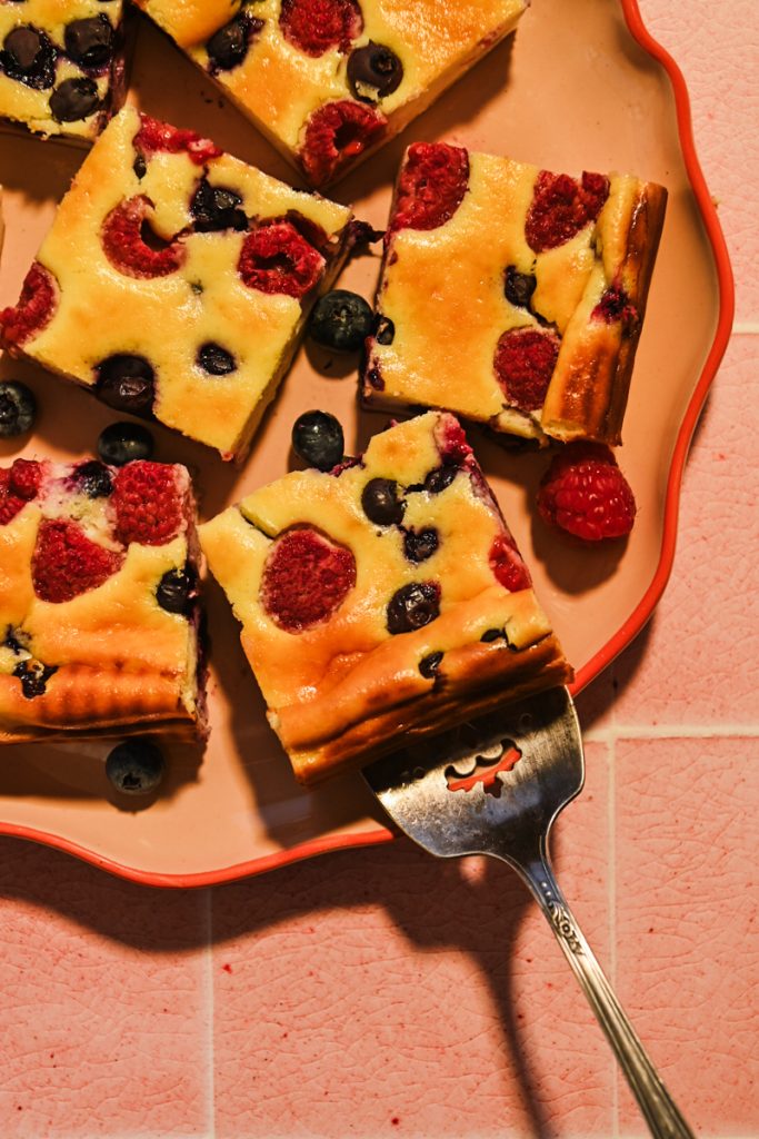 Plate with Crustless Yogurt Cheesecake Bars with Berries.