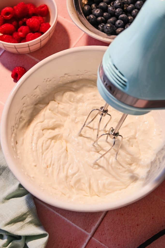 Whisking the cream cheese mixture in a bowl.