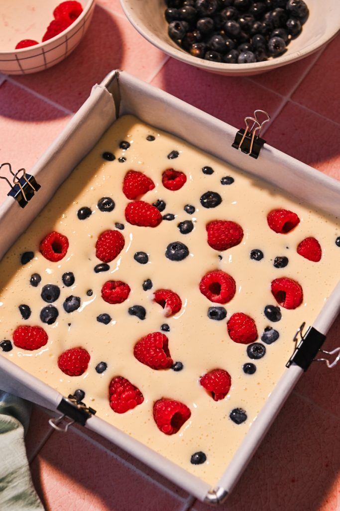 baking pan with the cream cheese mixture an berries.