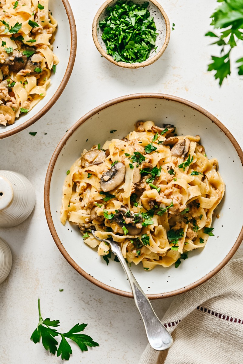 Two bowls of the dish with parsley on top.