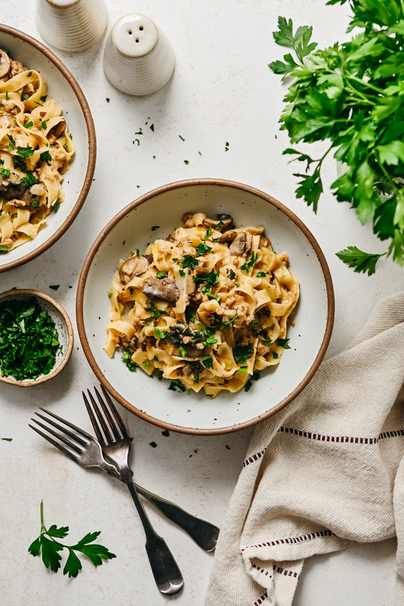 Ground veal stroganoff in a bowl garnished with parsley.