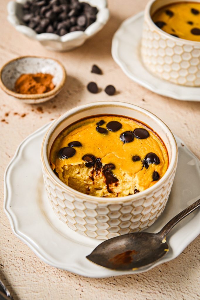 Baked pumpkin banana yogurt in a ramekin with golden top and melted chocolate chips.