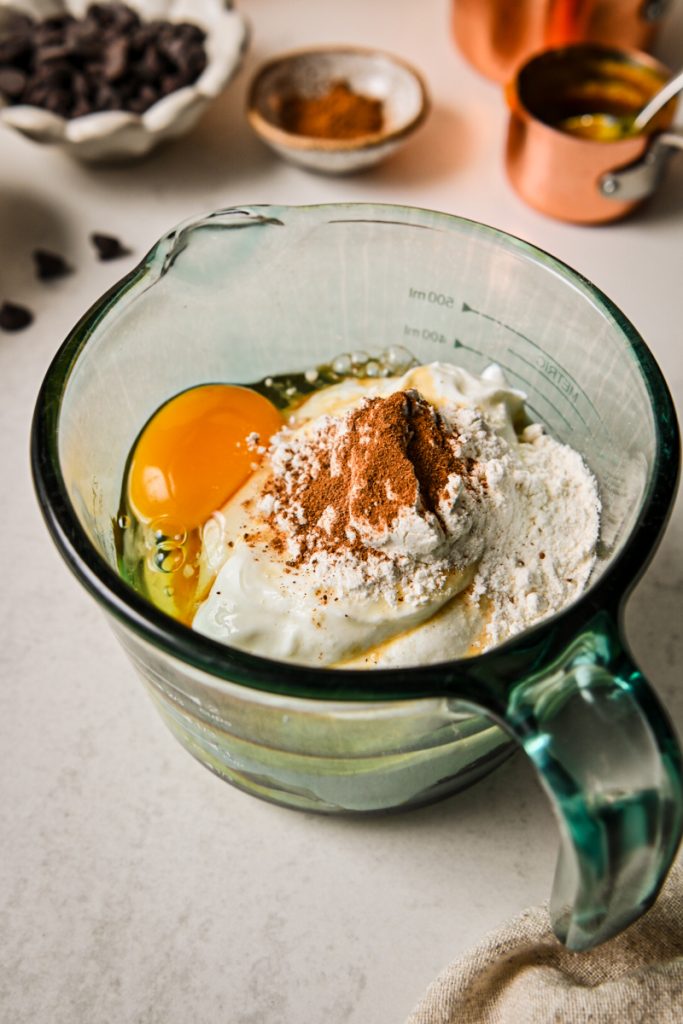 Egg, Greek yogurt, flour, and pumpkin spice layered in a cup.
