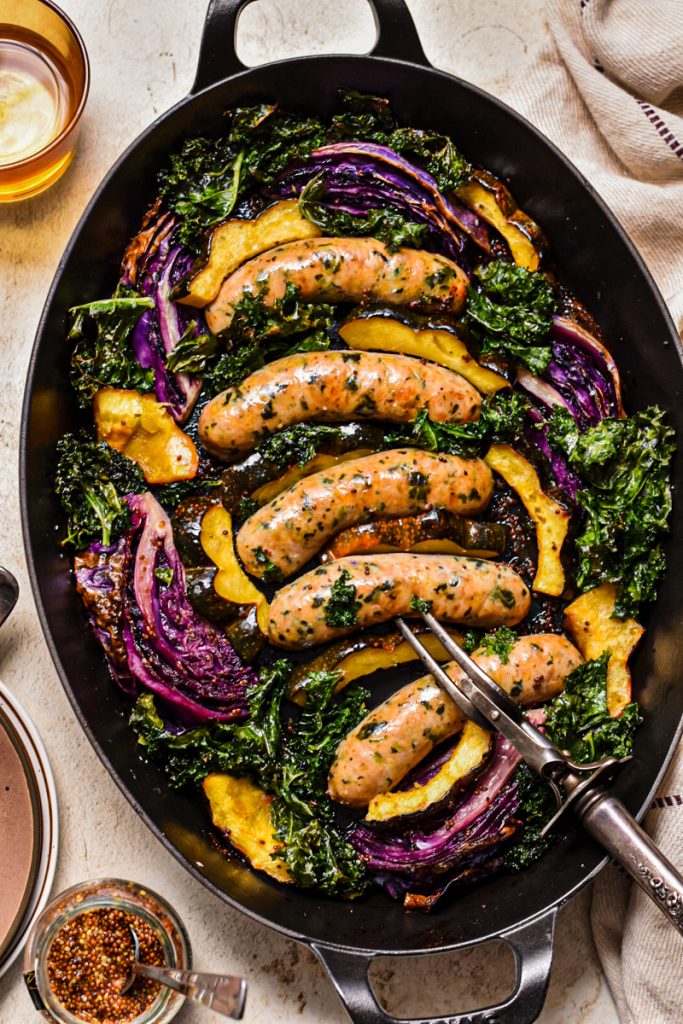Baking pan chicken sausage with roasted acorn squash, red cabbage, and kale.